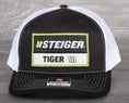 Load image into Gallery viewer, Steiger Tiger Tractor patch on a Richardson 112 trucker hat