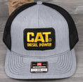 Load image into Gallery viewer, Vintage CAT Diesel Power patch on a Richardson 112 trucker hat
