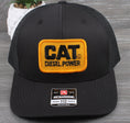 Load image into Gallery viewer, Vintage CAT Diesel Power patch on a Richardson 112 trucker hat
