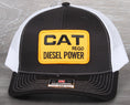 Load image into Gallery viewer, Vintage CAT Diesel Power patch on a Richardson 112 trucker hat
